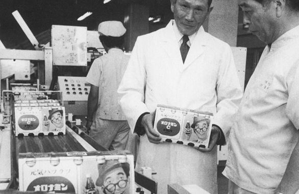 Man holding a crate of a carbonated nutritional drink